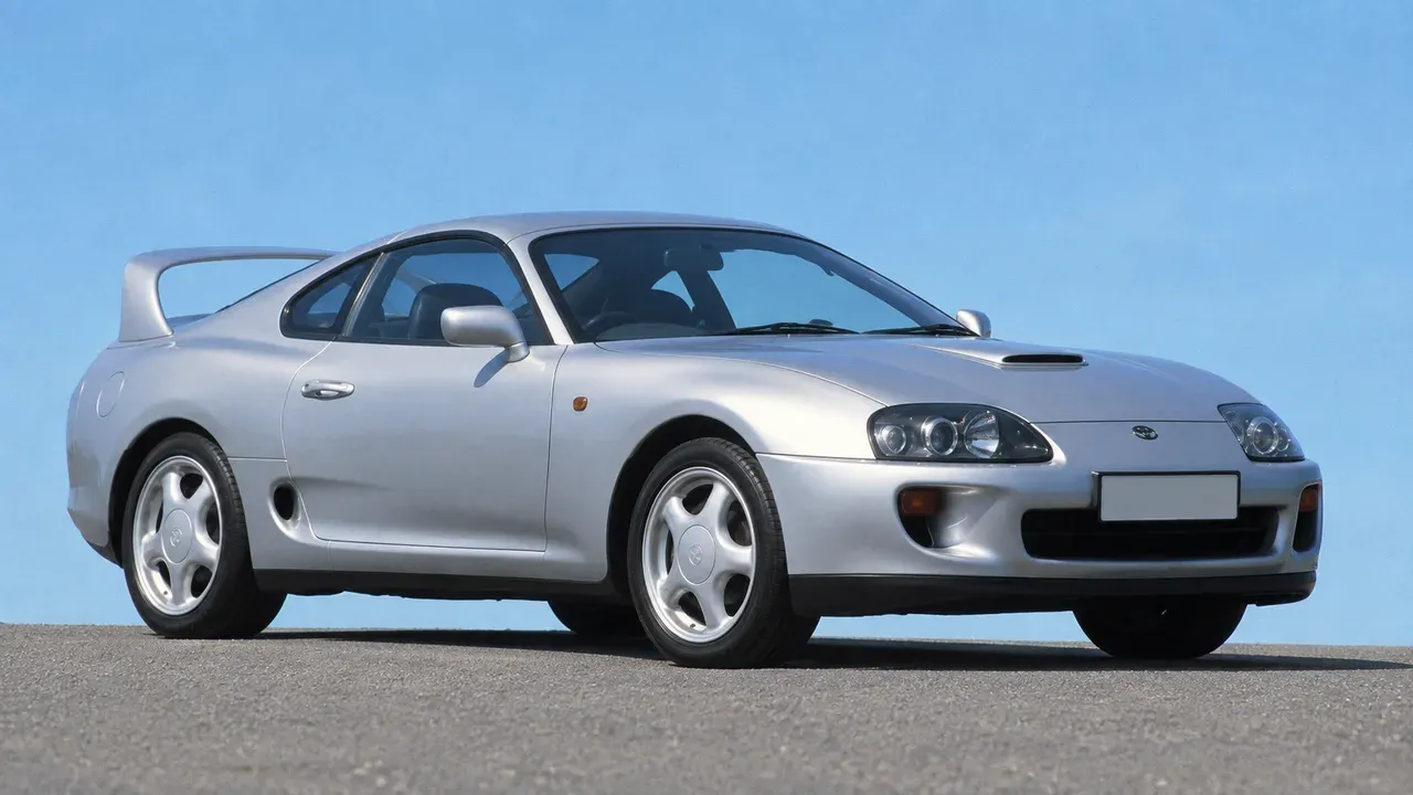 Stock white Toyota Supra A80 viewed from the front three-quarter angle
