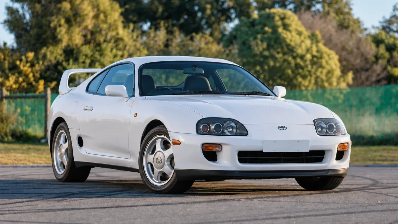 Stock white Toyota Supra A80 viewed from the opposite front three-quarter angle