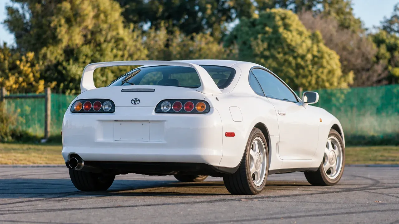 Stock white Toyota Supra A80 viewed from the rear three-quarter angle